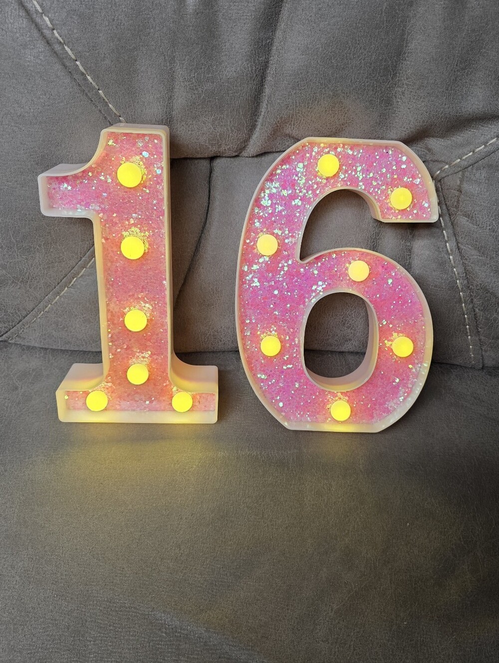 This is a pink glitter LED marquee number light, approximately 8.5 to 9 inches t